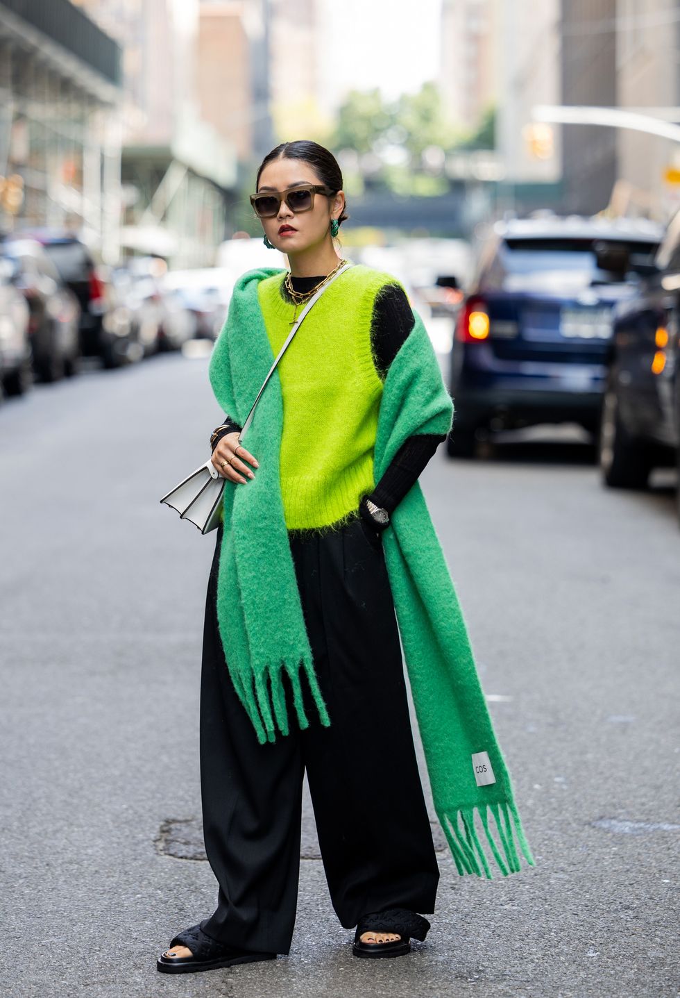 a person in a green dress walking down the street