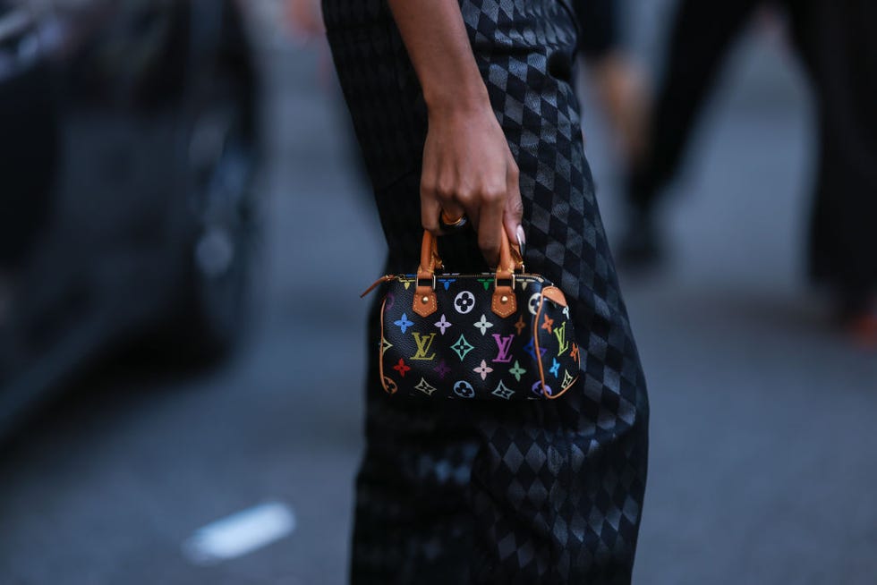 new york, new york september 10: fashion week visitor seen wearing a black look with loewe shades and louis vuitton mini speedy bag, outside patbo show during new york fashion week on september 10, 2022 in new york city. (photo by jeremy moeller/getty images)