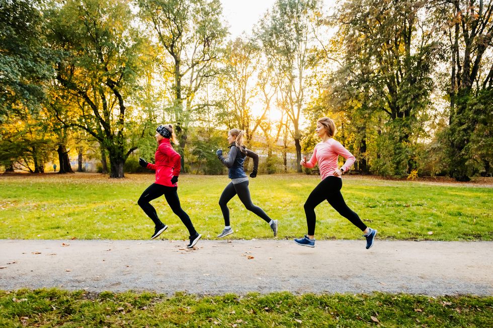three women running through a non urban area
