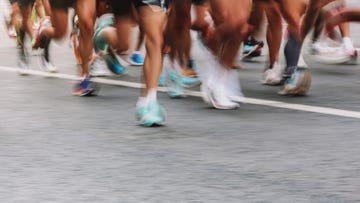 sports activities background people running marathon distance at the city street banner horizontal, ambient light, copy space, blurred motion