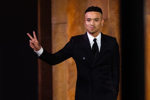 Rhuigi Villaseñor designer rhuigi villaseñor wears a tailored suit and gives a peace sign