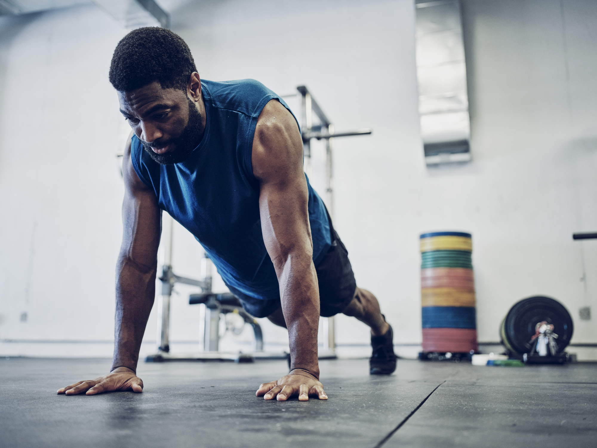 an athletic man cross training in a gym