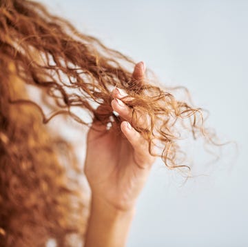 woman running fingers through curly hair