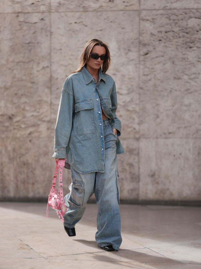 paris, france september 27 a fashion week guest seen wearing a matching amiri denim look with a balenciaga le cagole bag, outside mame kurogouchi during paris fashion week on september 27, 2022 in paris, france photo by jeremy moellergetty images