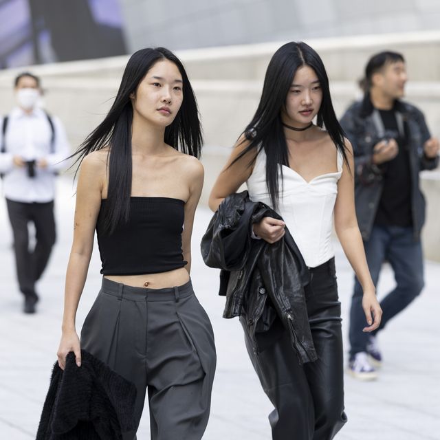 seoul, south korea october 14 guests wear a black top, grey pant with black shoes and a white top, leather pants and shoes outside dongdaemun design plaza at seoul fashion week ss 23 on october 14, 2022 in seoul, south korea photo by matt jelonekwireimage