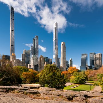 central park in fall with view of the skyscrapers of billionaires row midtown manhattan, new york city