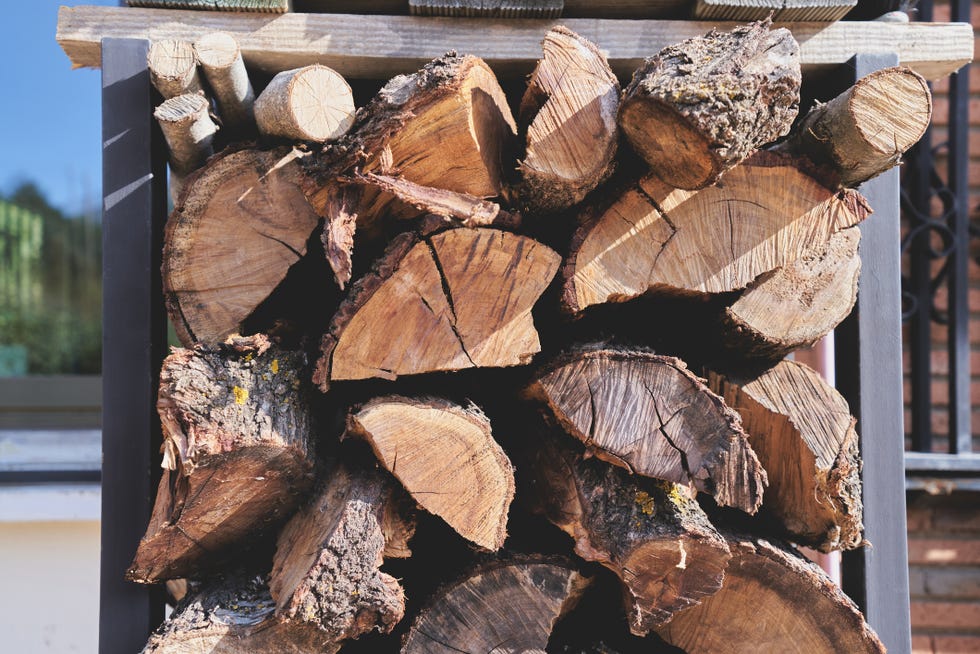 portrait of pile of rustic weathered wood logs, daytime outdoors front view