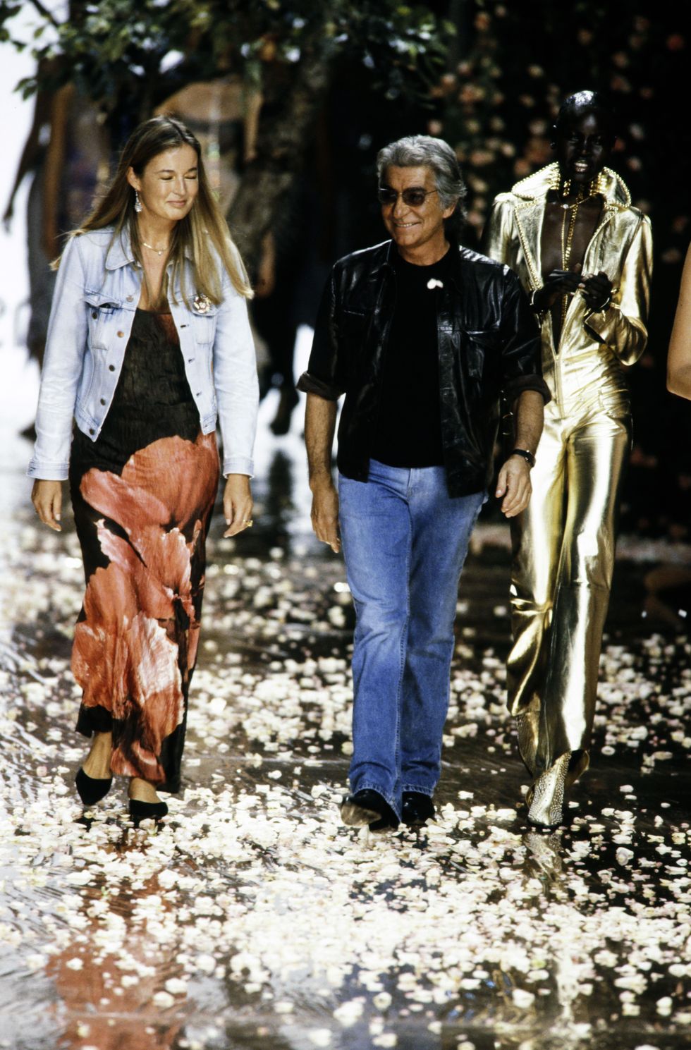 designer roberto cavalli walks the runway at show finale with wife eva cavalli and model alek wek photo by mauricio mirandapenske media via getty images
