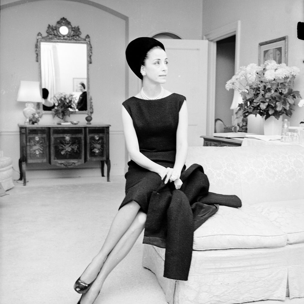 outtake gloria guinness seated in her suite at the waldorf towers wearing a black wool givenchy jacket bordered in black faille over a sleeveless dress with a black balenciaga hat and diamond ring and lapel pin as well as pearls and diamond and pearl earrings black round toe pumps completed the dinner outfit guinness owned the exact same outifts in mauve and blue linen with a beige hatarticle title mrs loel guinness photo by tony palmieriwwdpenske media via getty images