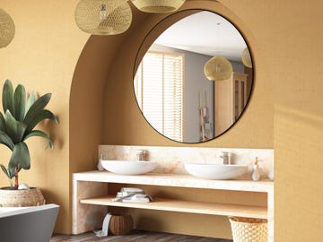 baño con espejo redondo