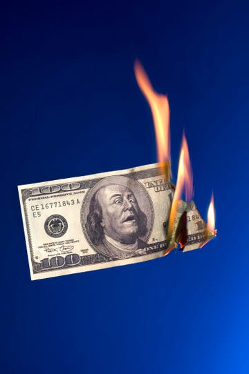 burning money on blue background