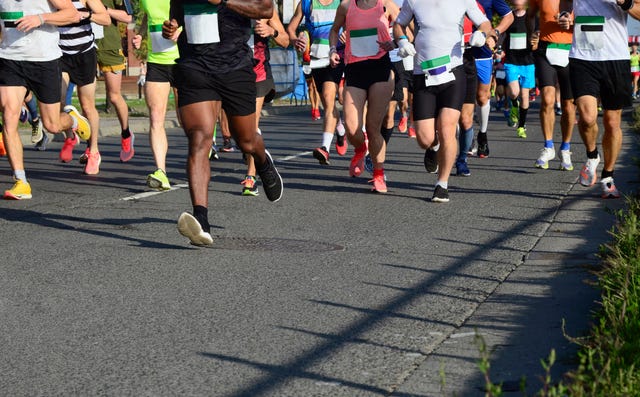 lady and gent runners competing on the streets of budapest, hungary