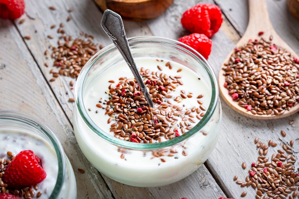 mixture of seeds, raspberries and yoghurt linseed, hemp, chia, psyllium