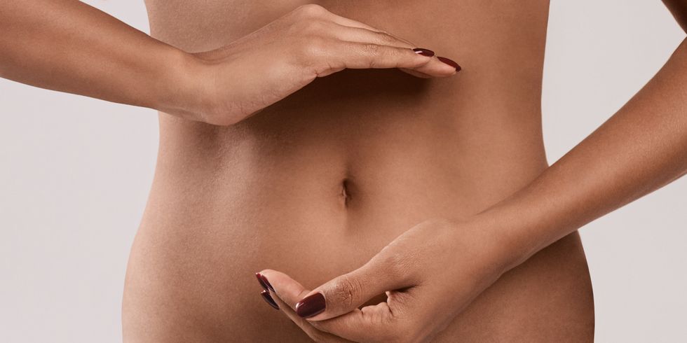 cropped image of slim black girl with protect gesture on stomach