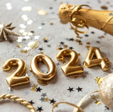 golden color palette photo with new year 2024 numbers surrounded by confetti and decorations