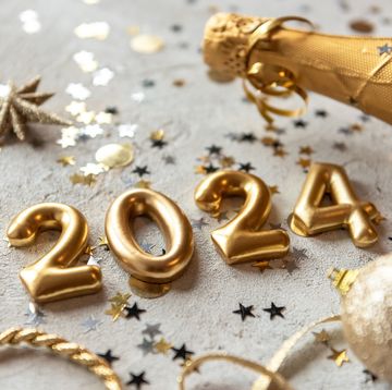 golden color palette photo with new year 2024 numbers surrounded by confetti and decorations