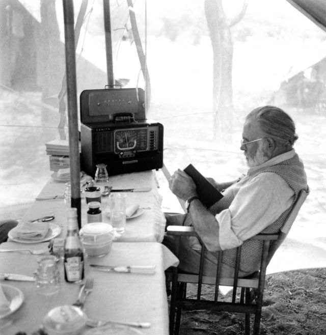 kenya   september 1952  author ernest hemingway reads and listens to the radio at the dining table while on a big game hunt in september 1952 in kenya  photo by earl theisengetty images