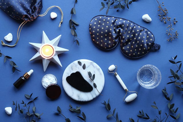 relaxation and skincare items arranged on a blue surface