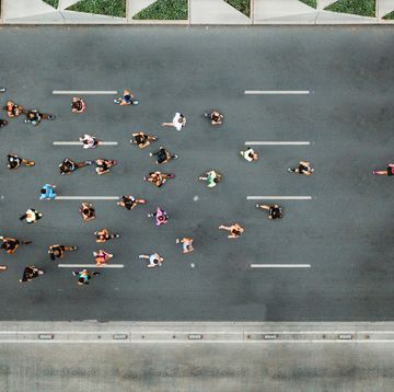 aerial view of marathon city runners one person leading marathon