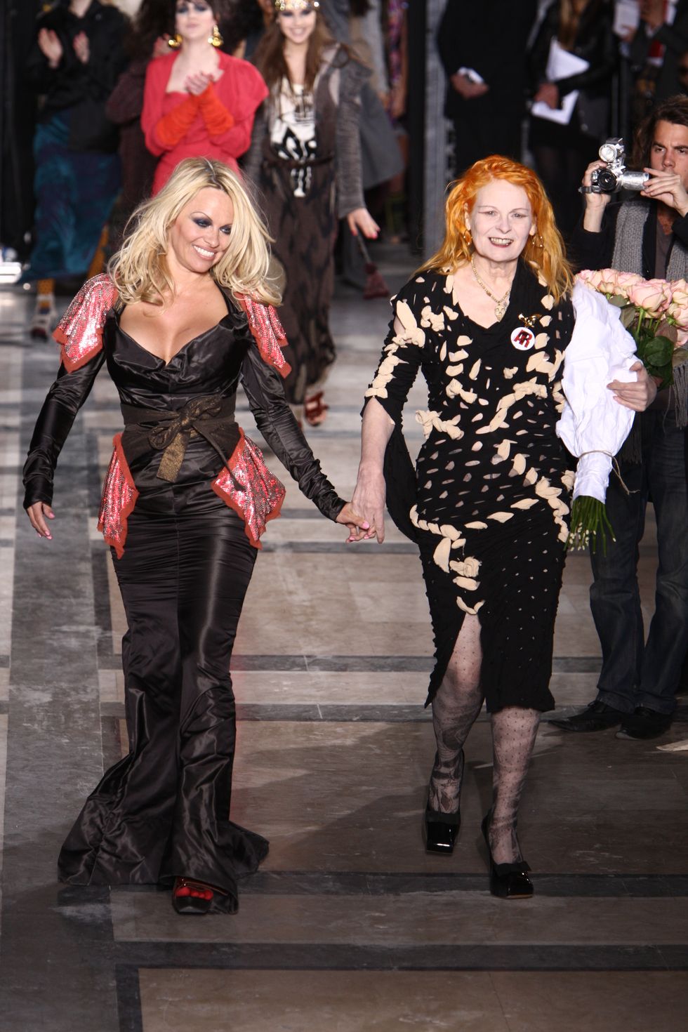 pamela anderson l and designer vivienne westwood on the runway after westwoods fall 2009 show at 7 place vendome in paris photo by fairchild archivepenske media via getty images