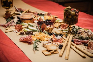 holiday grazing table with various meats, cheeses, vegetables, and crackers arranged on kraft paper