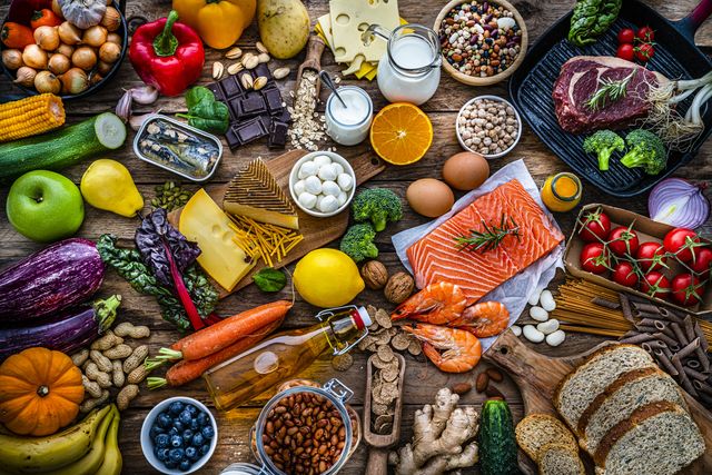 overhead view of a large group of all sort of food for a well balanced and healthy diet of proteins, dietary fiber, carbohydrates, vitamins and minerals the composition includes fruits, vegetables, fish, raw meat, beans, seeds and nuts, pasta, cooking oil, spices and dairy products high resolution 42mp studio digital capture taken with sony a7rii and zeiss batis 40mm f20 cf lens