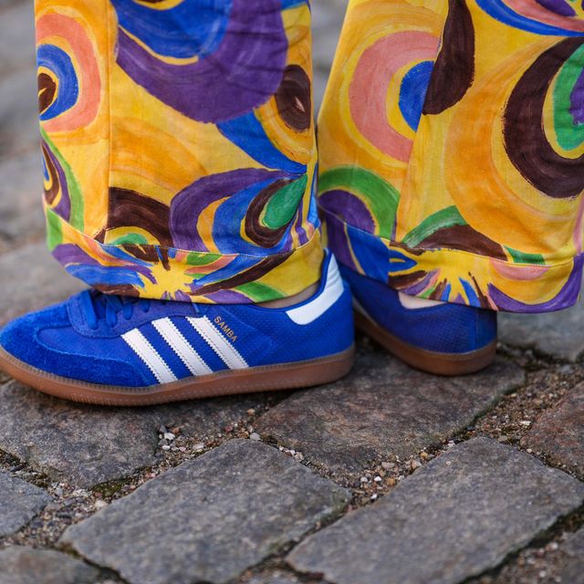 copenhagen, denmark february 02 a guest wears yellow with brown blue green print pattern large pants, royal blue suede sneakers from adidas , outside helmstedt, during the copenhagen fashion week autumnwinter 2023 on february 02, 2023 in copenhagen, denmark photo by edward berthelotgetty images