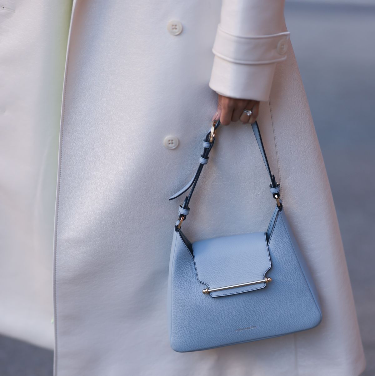 new york, new york february 10 miki cheung seen wearing white prada heels, a green pleated skirt, a white cropped blouse, a long white coat, a blue bag and black and silver sparkling chanel shades before the rodarte show on february 10, 2023 in new york city photo by jeremy moellergetty images
