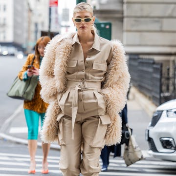new york, new york february 12 devon windsor wears beige button up jacket, pants with side pockets, animal print knee high boots, fleece fur coat outside puppets puppets during new york fashion week on february 12, 2023 in new york city photo by christian vieriggetty images