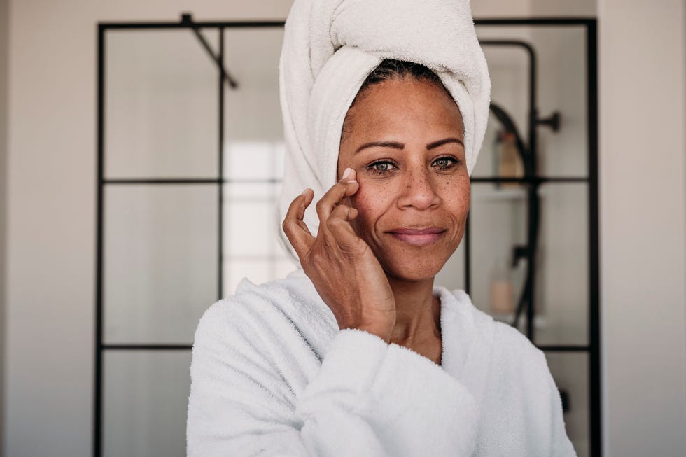 woman applying moisturiser