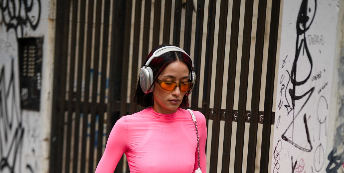 milan, italy february 24 alexandra guerain wears silver headphones, a pale pink long sleeves t shirt, a white shiny leather shoulder bag, orange sunglasses, red neon shiny leather large pants, red shiny lather heels shoes , outside sportmax, during the milan fashion week womenswear fallwinter 20232024 on february 24, 2023 in milan, italy photo by edward berthelotgetty images