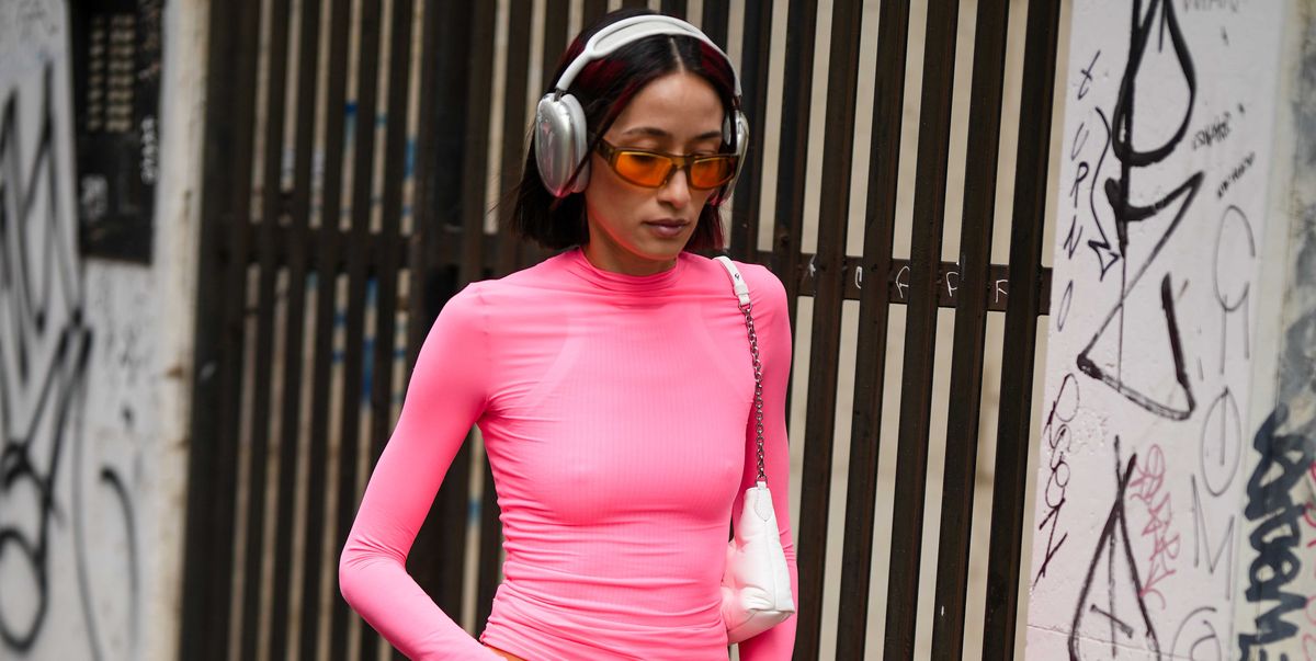 milan, italy february 24 alexandra guerain wears silver headphones, a pale pink long sleeves t shirt, a white shiny leather shoulder bag, orange sunglasses, red neon shiny leather large pants, red shiny lather heels shoes , outside sportmax, during the milan fashion week womenswear fallwinter 20232024 on february 24, 2023 in milan, italy photo by edward berthelotgetty images