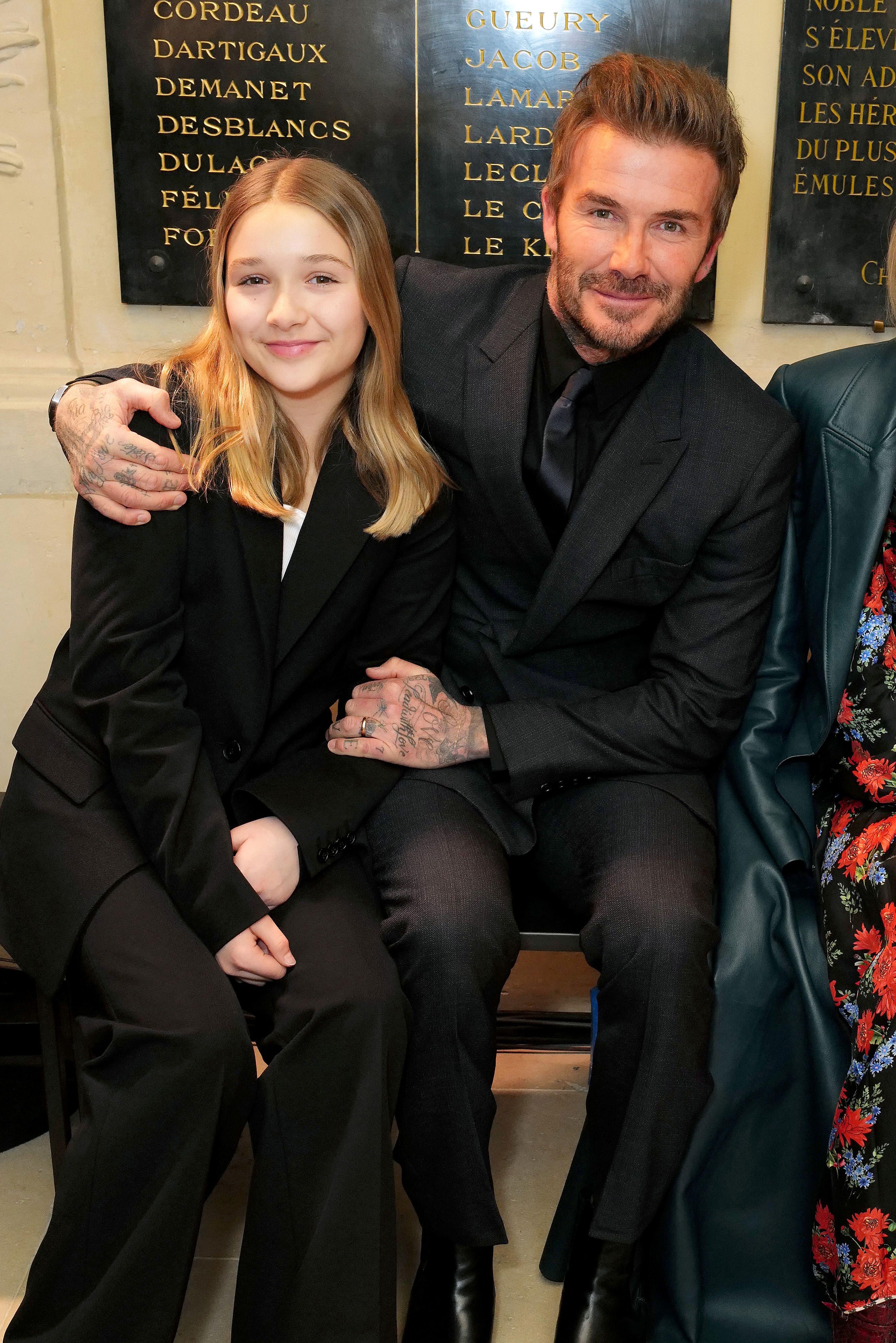 David Beckham sings with daughter Harper at an Elton John concert