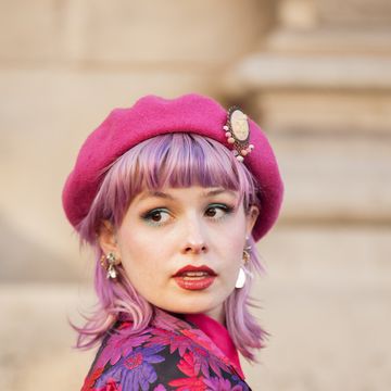 paris, france march 03 a guest with pink hair is seen wearing red, pink, purple and black flower pattern jacket, matching color checkered skirt, pink beret and pink bag outside the nina ricci show during paris fashion week womenswear fall winter 2023 2024, on march 03, 2023 in paris, france photo by raimonda kulikauskienegetty images