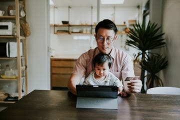 asian single dad trying to paying some toy for his babygirl on online store.
