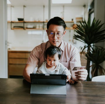 Asian single father paying on online store with credit card. asian single dad trying to paying some toy for his babygirl on online store.