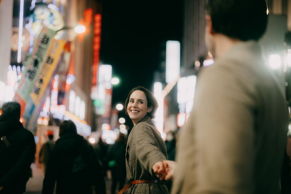 beautiful woman enjoying tokyo with her date at night in winter
