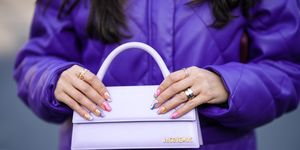 paris, france march 01 samia laaboudi wears a silver love ring from cartier, rings, a pale purple shiny leather handbag from jacquemus, a neon purple shiny leather bomber coat , outside cecilie bahnsen, during paris fashion week womenswear fall winter 2023 2024, on march 01, 2023 in paris, france photo by edward berthelotgetty images