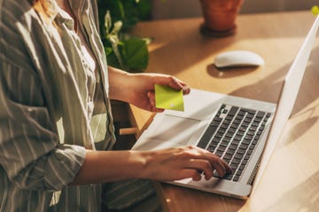 hands holding plastic credit card and using laptop. online shopping concept. toned picture