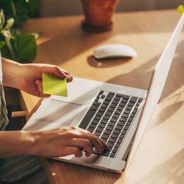 Hands holding plastic credit card and using laptop. Online shopping concept. Toned picture hands holding plastic credit card and using laptop. online shopping concept. toned picture