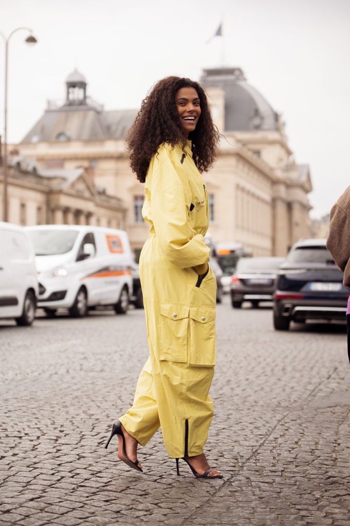 paris, france march 06 tina kunakey is seen wearing a yellow one piece or cargo jumpsuit with pockets and black zippers and black heels outside the stella mccartney show during paris fashion week womenswear fall winter 2023 2024 on march 06, 2023 in paris, france photo by raimonda kulikauskienegetty images