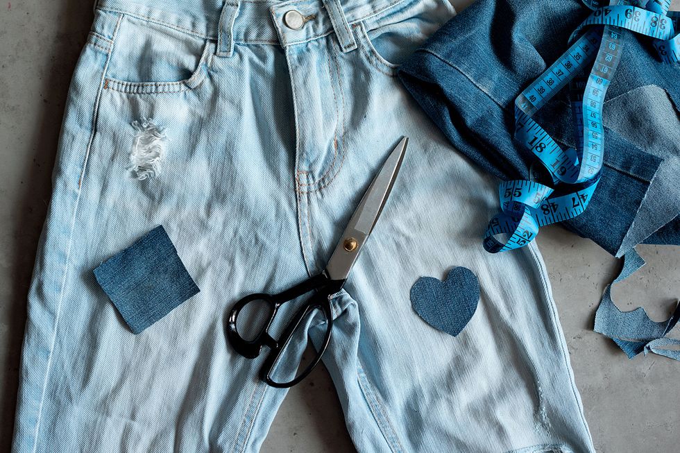 a pair of scissors on a person's jeans pocket