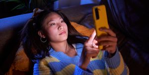 asian girl using mobile phone, texting and surfing on social media