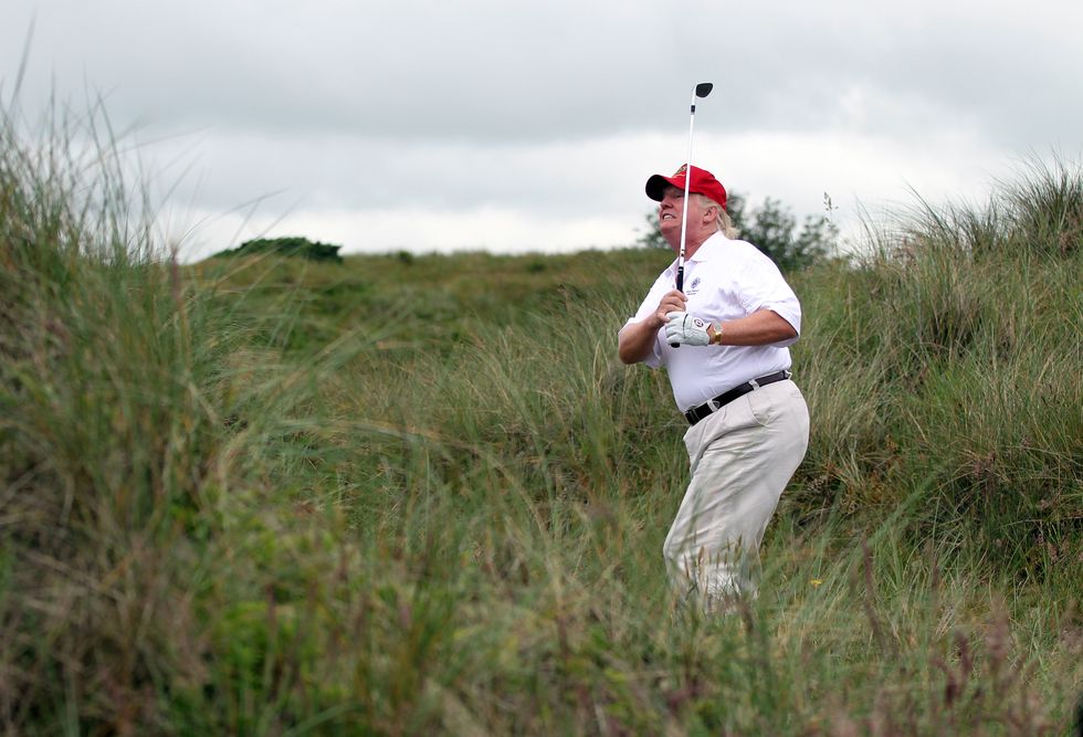aberdeen, scotland   july 10  donald trump plays a round of golf after the opening of the trump international golf links course on july 10, 2012 in balmedie, scotland the controversial £100m course opens to the public on sunday july 15 further plans to build hotels and homes on the site have been put on hold until a decision has been made on the building of an offshore windfarm nearby photo by ian macnicolgetty images