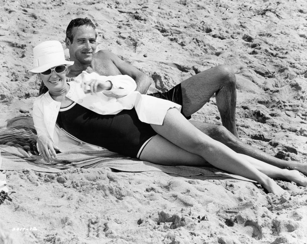 Joanne Woodward and Paul Newman relax on the beach between races in a scene from the film 'Winning,' 1969.