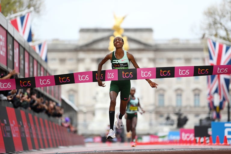 a runner crossing the finish line in a marathon event