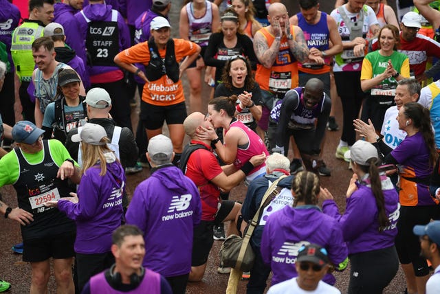london, england april 23 a couple embrace after a proposal on the finish line during the 2023 tcs london marathon on april 23, 2023 in london, england photo by alex davidsongetty images