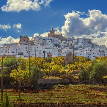 traditional white houses and old bell tower, ostuni, province of brindisi, salento, apulia, italy
