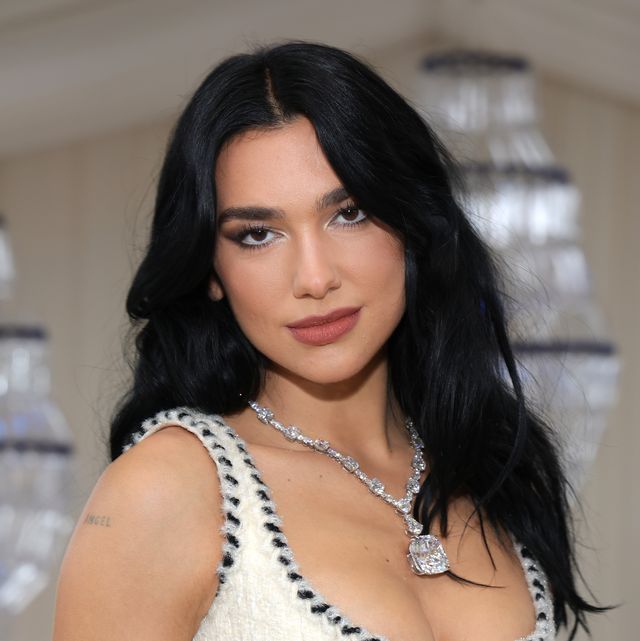Dua Lipa styles her hair with a grown-out fringe in Cannes