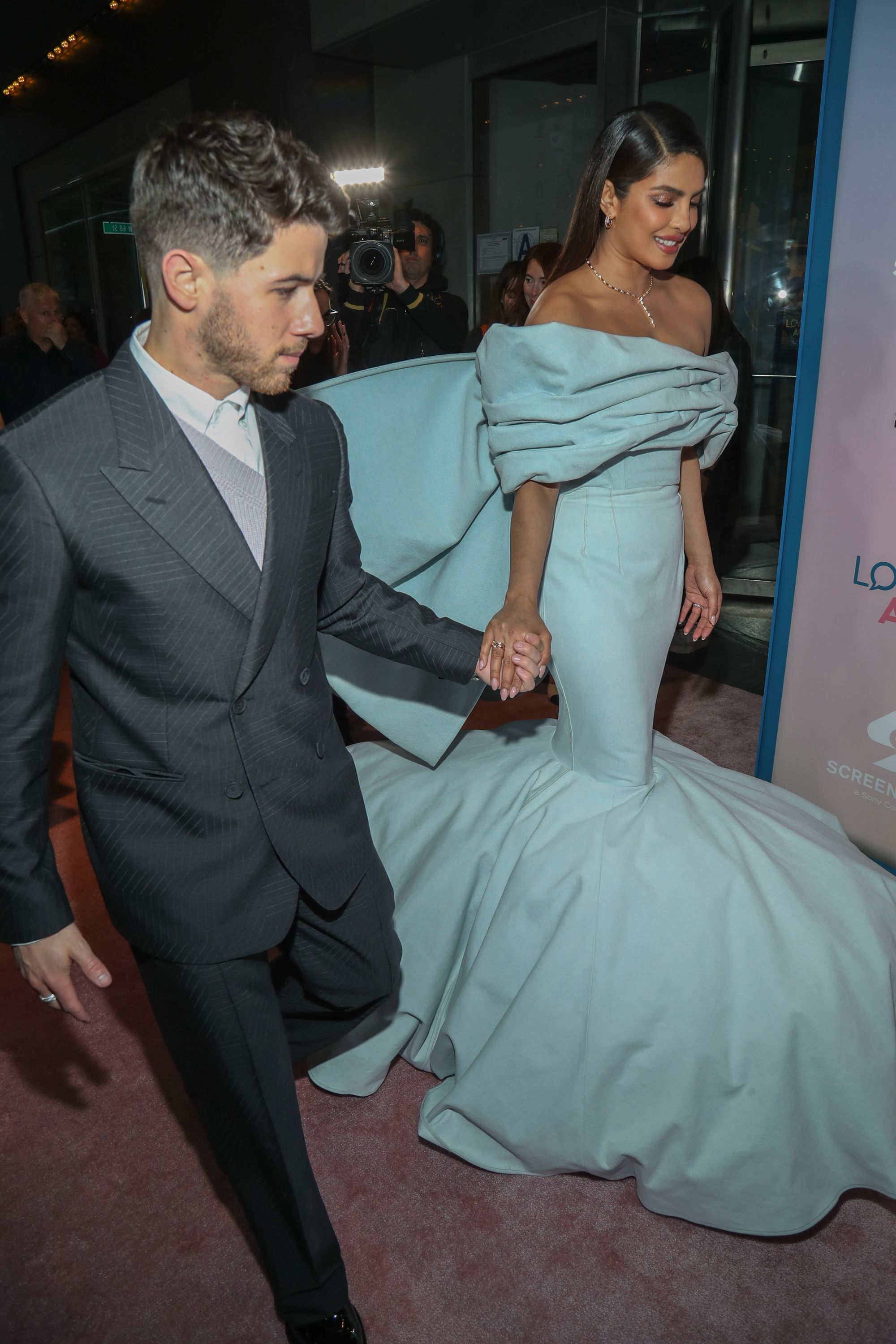 With Nick Jonas In A Black Suit, Priyanka Chopras Black Valentino Gown Came  With A Waist High Slit And White Gloves As A Nod To Karl Lagerfeld